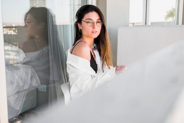 beautiful-young-woman-sitting-balcony_23-2148161268-7970017