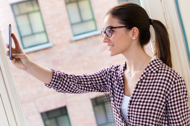 beautiful-young-woman-using-her-mobile-phone-office_1301-3844-1402831