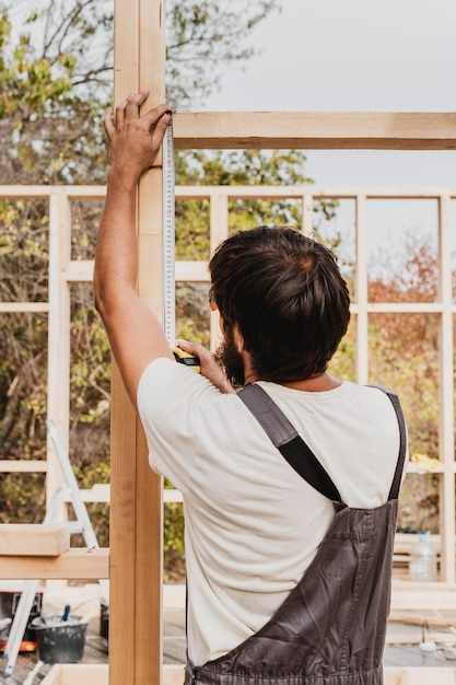 carpenter-man-using-tape-measure-from-shot_23-2148748800-6549423