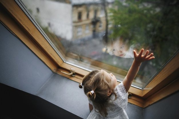 little-girl-is-looking-out-window_8353-9335-2886953