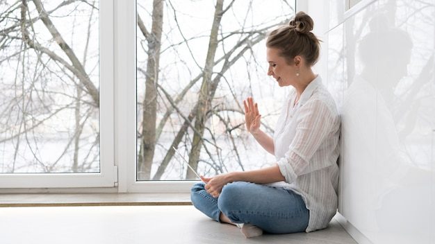 side-view-woman-sitting-floor_23-2148504730-8940333